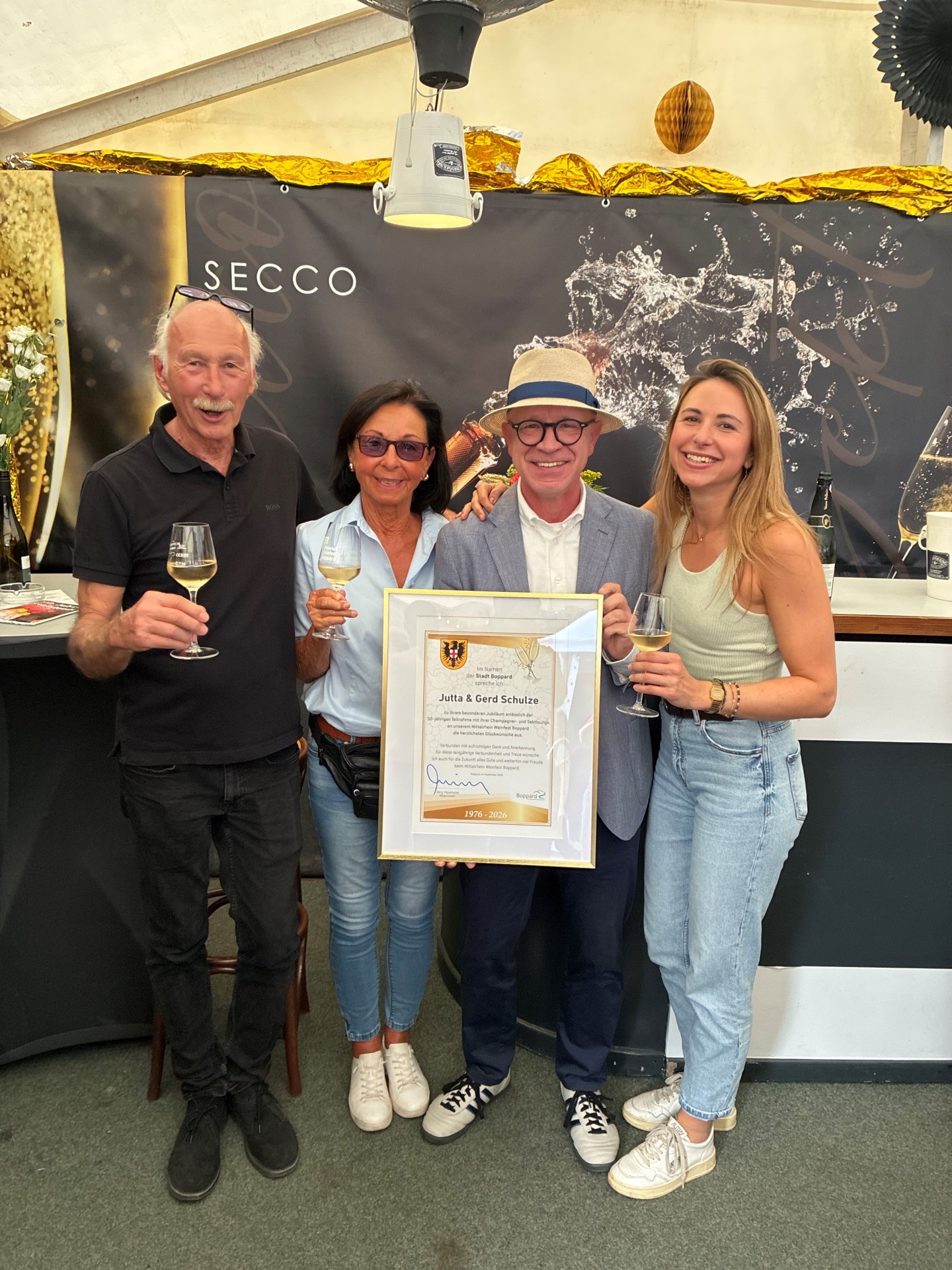 Seit 50 Jahren sind Jutta (2. von links) und Gerd Schulze (links), auf dem Foto mit Tochter Anna Schulze (rechts), mit ihrer Champagner- und Sektlounge ein fester Bestandteil des traditionsreichen Bopparder Weinfestes. Aus diesem besonderen Anlass überreichte Bürgermeister Jörg Haseneier den Standbetreibern eine Urkunde und würdigte damit die jahrzehntelange Verbundenheit mit dem Bopparder Weinfest.